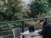 A person reading and planning for the new year at an outside table.